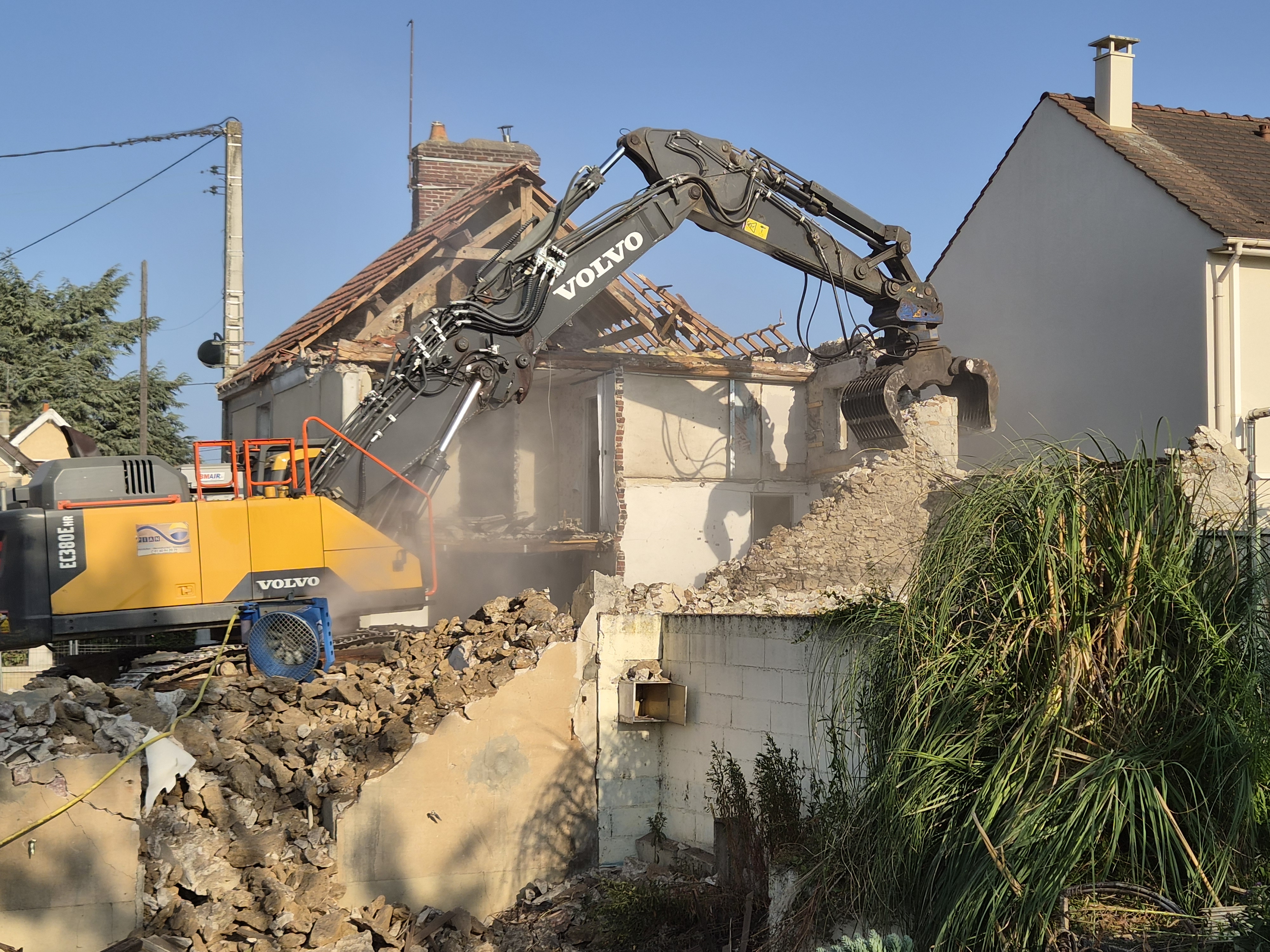 Pelle Volvo équipée d'une pince de démolition sur un chantier de déconstruction